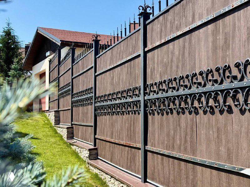 Крупный план высокого забора из древесно‑полимерной доски с декоративной металлокованой вставкой, стойкое цветовое покрытие, отсутствие дефектов