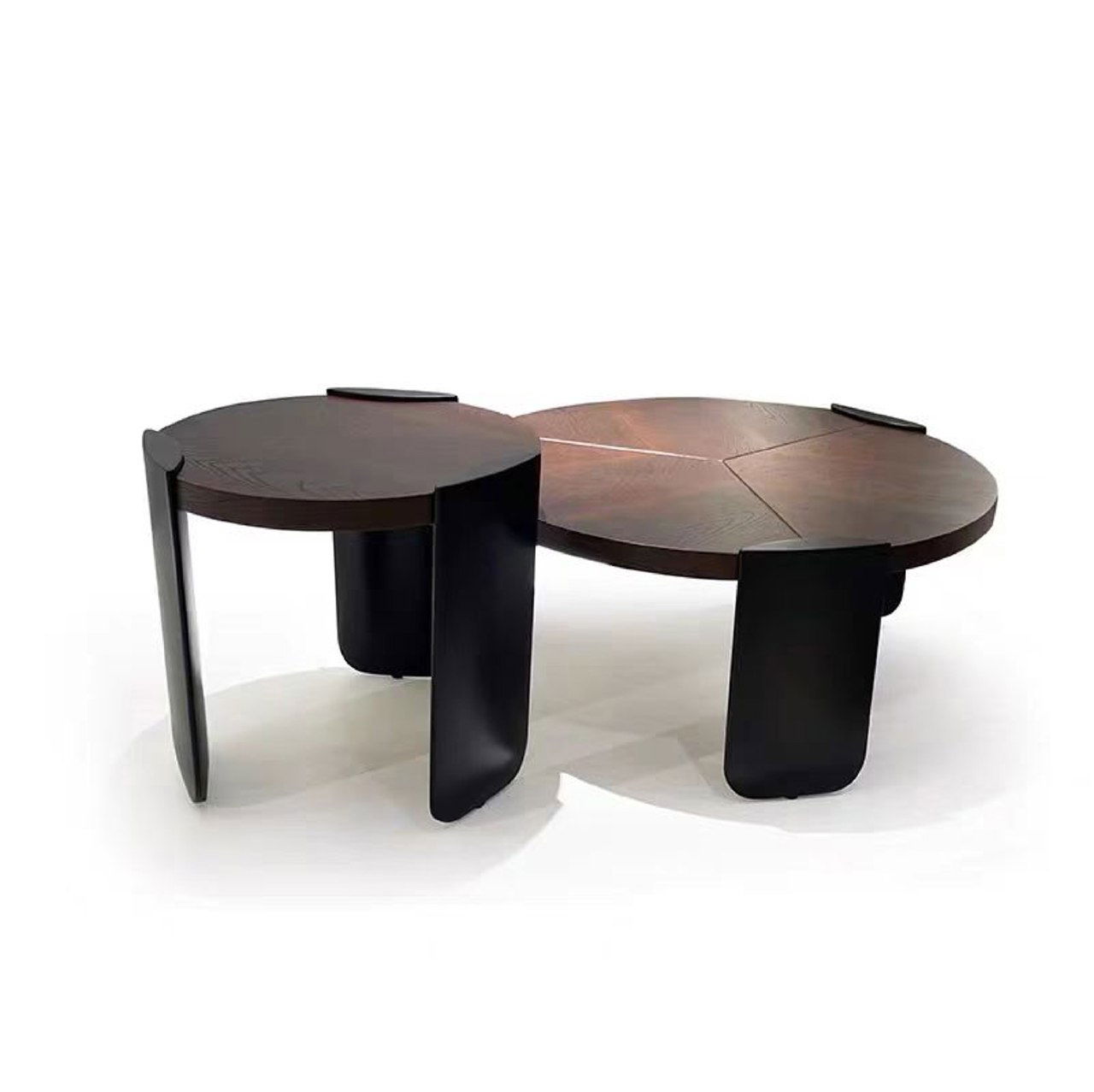 Студийный снимок двух круглых журнальных столиков из массива дуба тёмно-коричневого оттенка на белом фоне, с чёрными изогнутыми ножками и видимыми древесными текстурами.