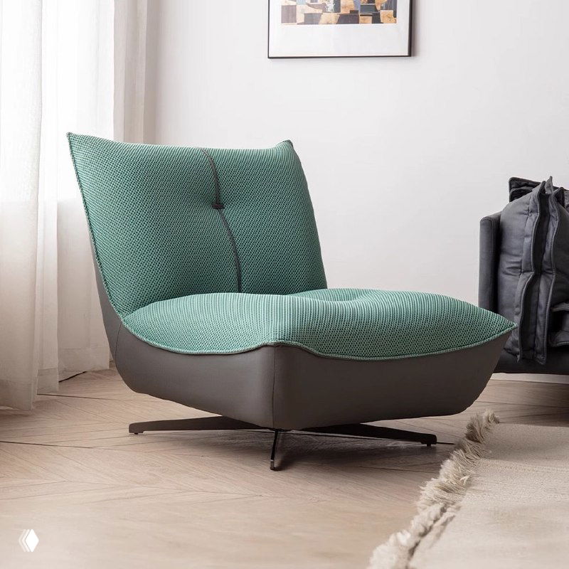 Фотография современного кресла в интерьере: зелёная стёганая обивка, низкая посадка, деревянный каркас и ножки из нержавеющей стали.