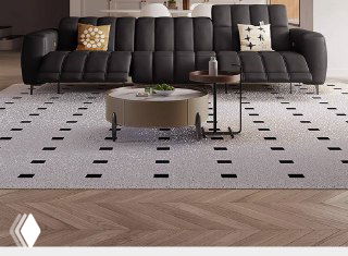 Тёмно-серый модульный диван с ровной линией спинки и низкими ножками, показан в минималистичном интерьере с ковром и журнальным столиком