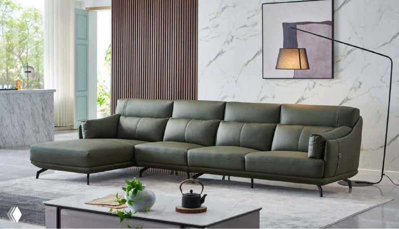 Угловой кожаный диван тёмно-серого цвета в светлой гостиной: вид спереди, подчеркнуты посадочные места, современный интерьер.