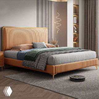 Кровать в тёплой коричнево-рыжей кожаной обивке с золотистыми ножками, акцент на отделку и дизайн изголовья.