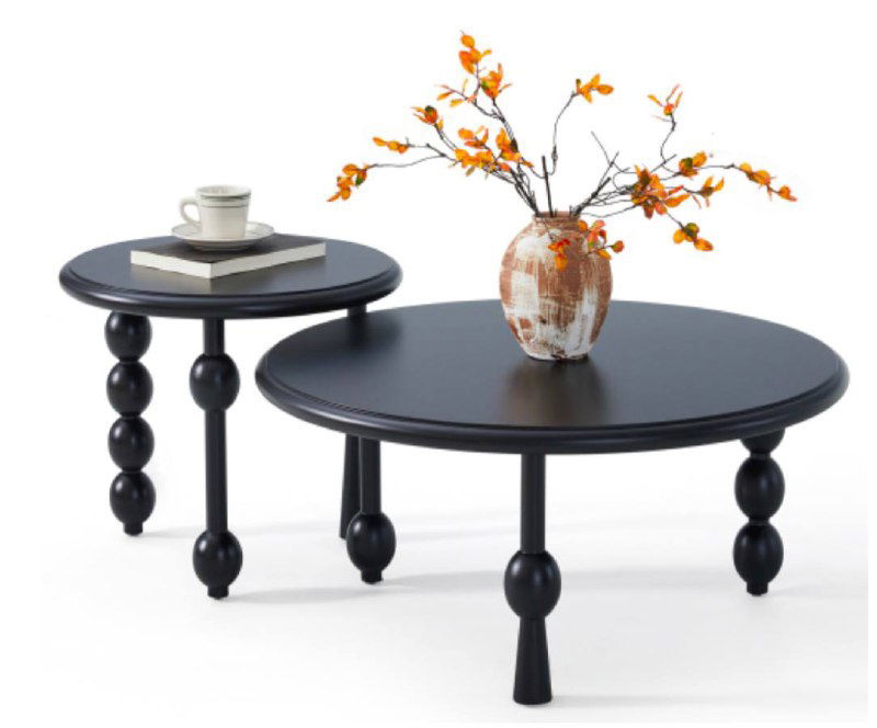 Набор круглых журнальных столиков чёрного цвета с декоративными круглыми ножками, акцент на форме и контрасте в светлом помещении.