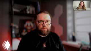 Скриншот видеозаписи прямого эфира: крупный план Кирилла Бадаева в очках на фоне домашней или офисной обстановки, участник в миниатюре в углу.