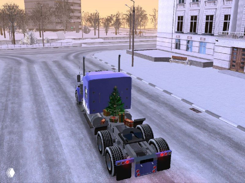 Задняя часть тягача Kenworth W900L с подключенной рамой и заметным новогодним декором в виде ёлки на раме — зимняя улица и бордюры в кадре.