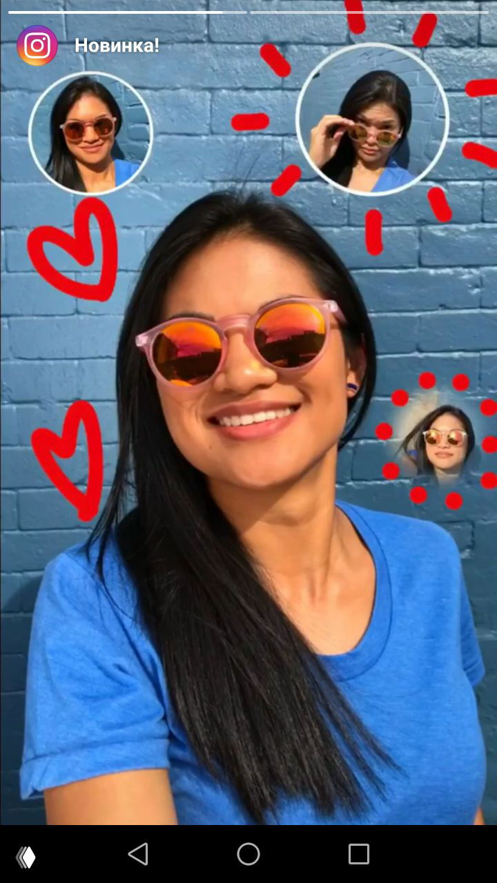 Девушка в розовых солнцезащитных очках улыбается на фоне синей кирпичной стены; вокруг неё мини-аватары и сердечки — демонстрация селфи-стикеров в Instagram Stories.