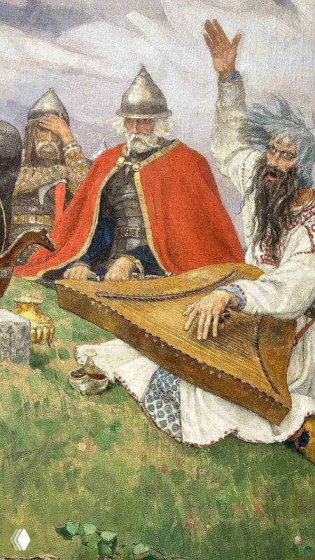 Фото с выставки Васнецова: фрагмент полотна с несколькими сидящими фигурами и музыкантом, переданы ткани, лица и приглушённые цвета масла.