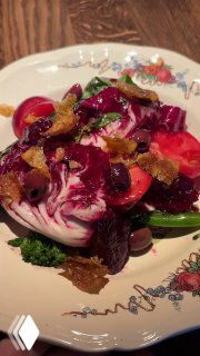 Овощной салат с тосканским кейлом, свёклой, брокколини и оливками на винтажной тарелке в боке ресторана — яркие краски блюда