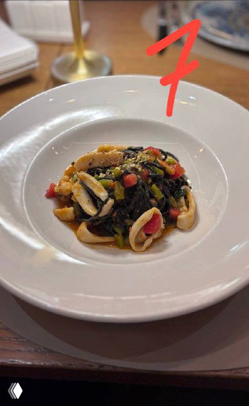 Небольшая порция пасты с морепродуктами и тёмным соусом — паста №7 в подборке, видна структура ингредиентов и сервировка.