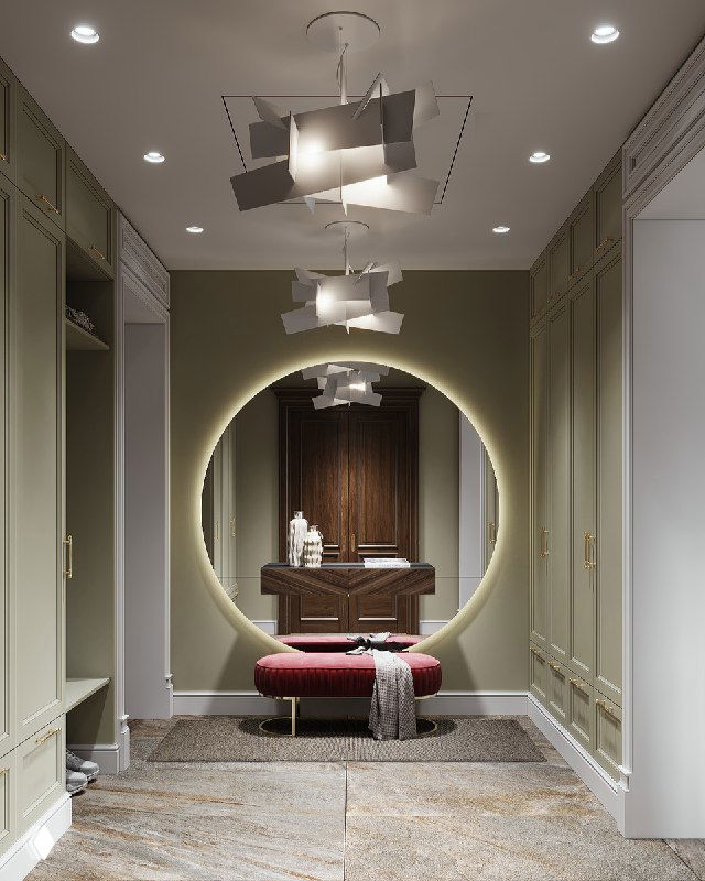 Прихожая с большим круглым зеркалом и подсветкой, насыщенной коралловой банкеткой и современной геометричной люстрой.