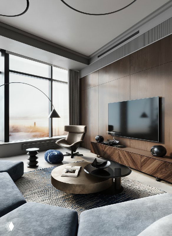 Уютный угол гостиной с панорамным окном, шпонованной деревянной стеной, креслом для отдыха, круглым журнальным столиком и синим пуфом на полу.