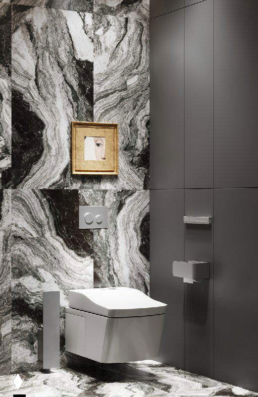 Крупный план на унитаз и нишу с маленькой картиной в золотой раме на фоне мраморно-ориентированного керамогранита и скрытых инженерных фасадов МДФ.