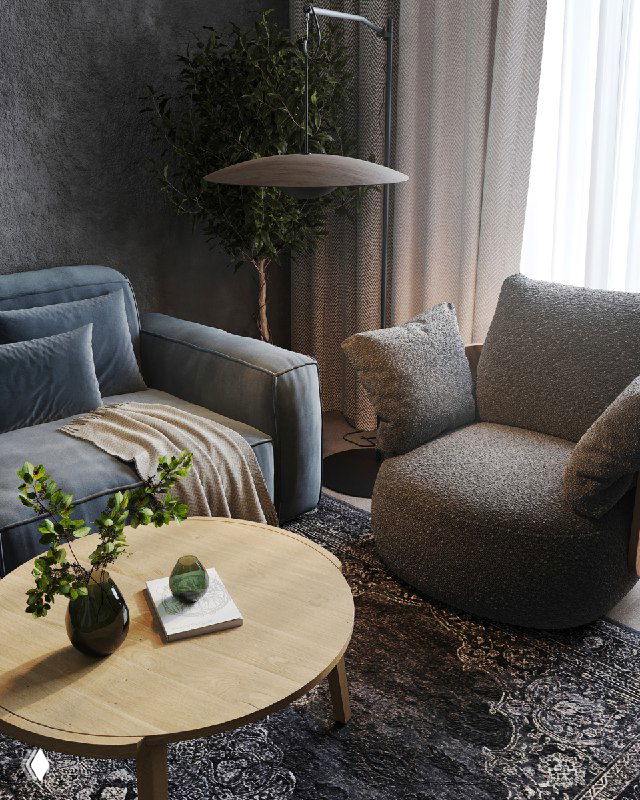 Крупный план уголка гостиной: глубокий синий диван Tamamm, мягкое кресло с деревянными вставками и кофейный стол на текстурном ковре.