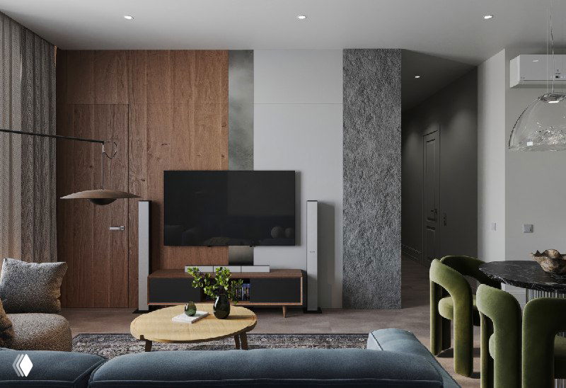 ТВ-зона с панелями под дерево, металл и камень; телевизор встроен в композицию, на переднем плане журнальный стол и часть синего дивана.