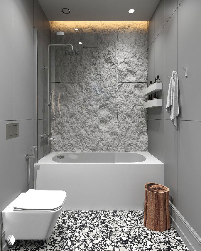 Фрагмент стены с каменной фактурой за ванной, аккуратная ниша для хранения, встроенная подсветка и монохромные панели вокруг ванны.