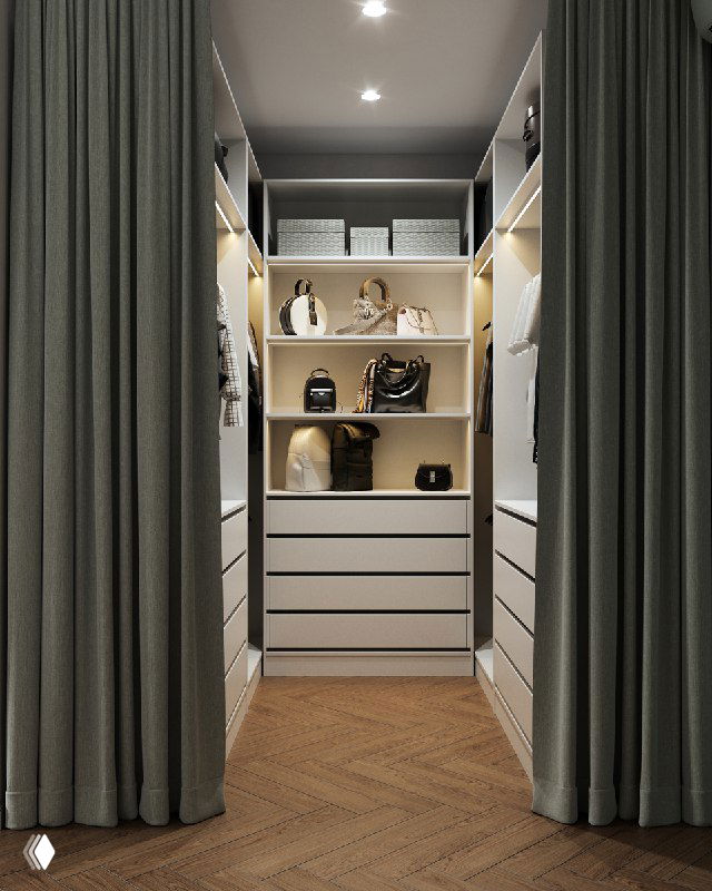 Вид в гардеробную за зелёной бархатной шторой: организованные полки и ящики с сумками и коробками, проход и деревянный тёплый паркет.