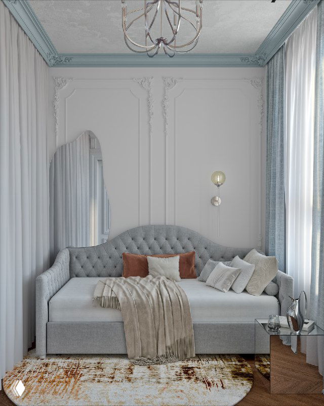 Интерьер спальни в пастельных голубых тонах: диван-кровать с мягкими подушками, теплый ковер и лепной карниз на потолке, создающие воздушную атмосферу.