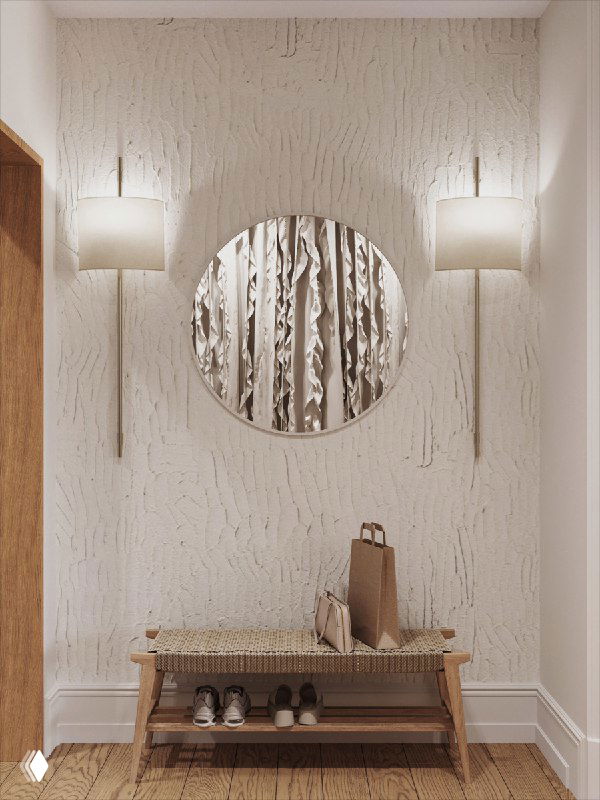 Фактурная штукатурка, круглое зеркало и плетёная скамья у входа: тёплая натуральная палитра, выраженная текстура и комфортная зона ожидания у входа в квартиру.