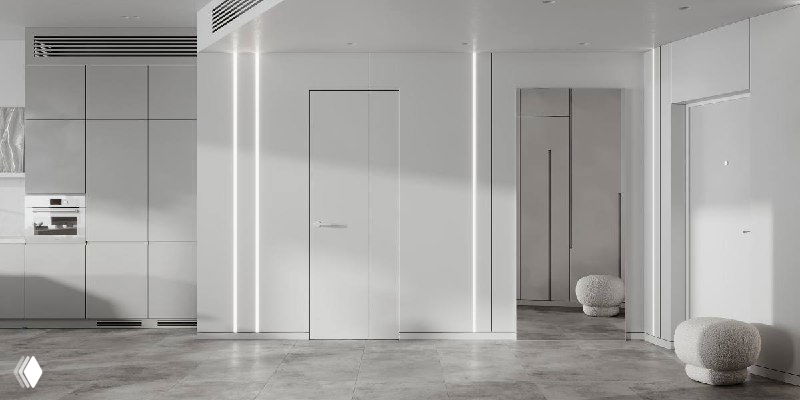 Минималистичный входной холл проекта «Швейцарские Альпы»: белые панельные стены, вертикальные скрытые двери, мягкий пуфик и рассеянное естественное освещение.