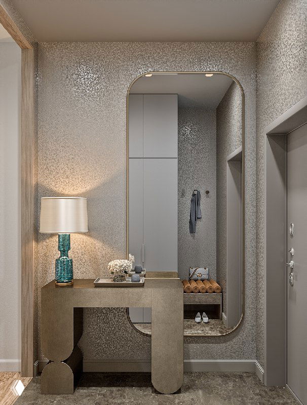 Фрагмент прихожей с зеркалом над консолью, настольной лампой и декоративными аксессуарами — тёплый фон и тёмный пол, визуальный проект GRADIZ.