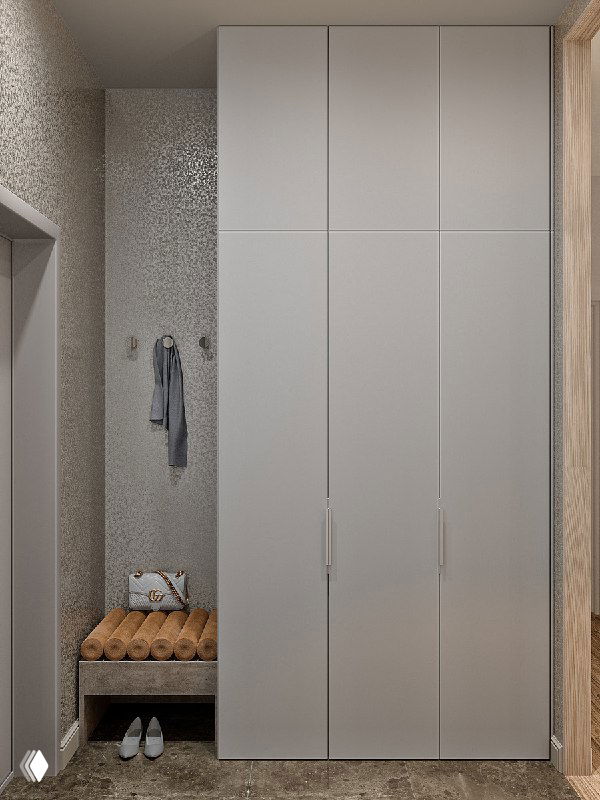 Шкаф и мини-банкетка в терракотовых тонах, встроенный шкаф для верхней одежды замаскирован под стену — вид слева от входа.