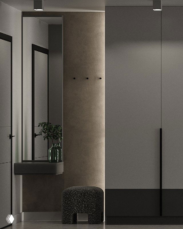 Минималистичная прихожая с большим зеркалом, подвесной консолью и дизайнерским пуфом Sfera; тёплая подсветка, декоративная штукатурка и вместительный шкаф.