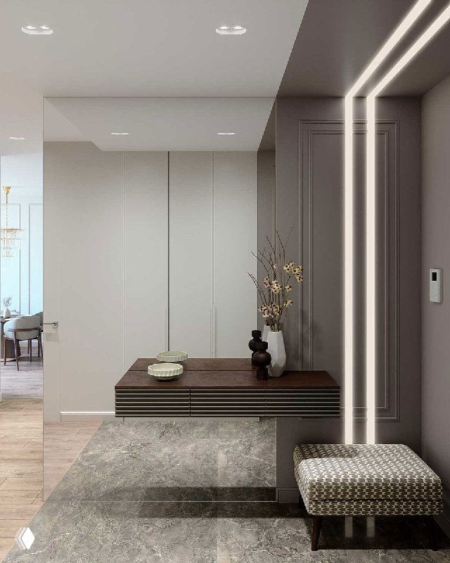 Прихожая с подвесной консолью и пуфом на фоне большого зеркала; замаскированный встроенный шкаф, декоративные молдинги и плавная LED-подсветка.