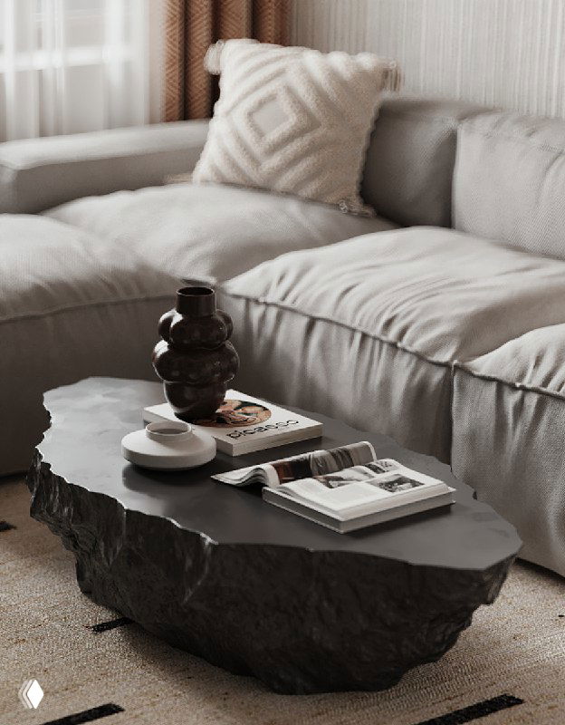 Крупный план низкого столика в виде скалы на фоне мягкого дивана и элементов декора в уютной гостиной с фактурной отделкой.
