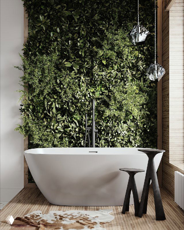 Отдельно стоящая белая ванна у стены с плотной зелёной фитостеной, деревянный пол и два тёмных табурета — уютный интерьер.