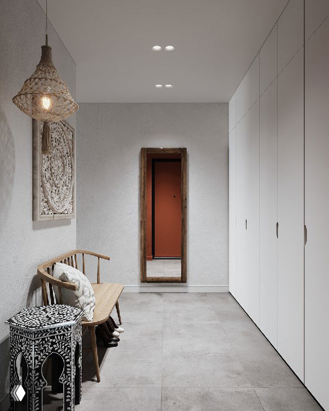 Длинная перспектива прихожей: белые встроенные шкафы вдоль стены, в конце ростовое зеркало в деревянной раме напротив входа, пол плитка серого тона.