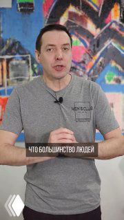 Мужчина в футболке на фоне красочной стены объясняет советы по выбору дивана — кадр из видео с рекомендациями по дизайну гостиной и расстановке мебели.