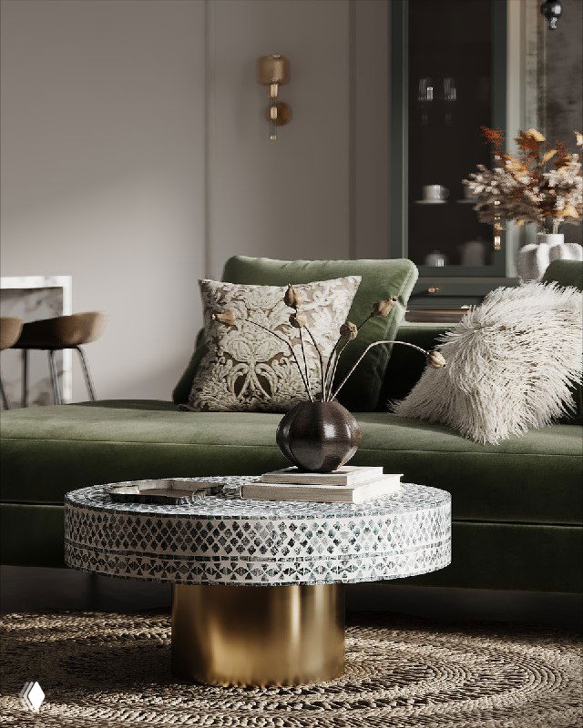 Интерьер гостиной с глубоким зеленым велюровым диваном, круглым столом из ракушек и ажурным плетёным ковром, создающими «летний сад».