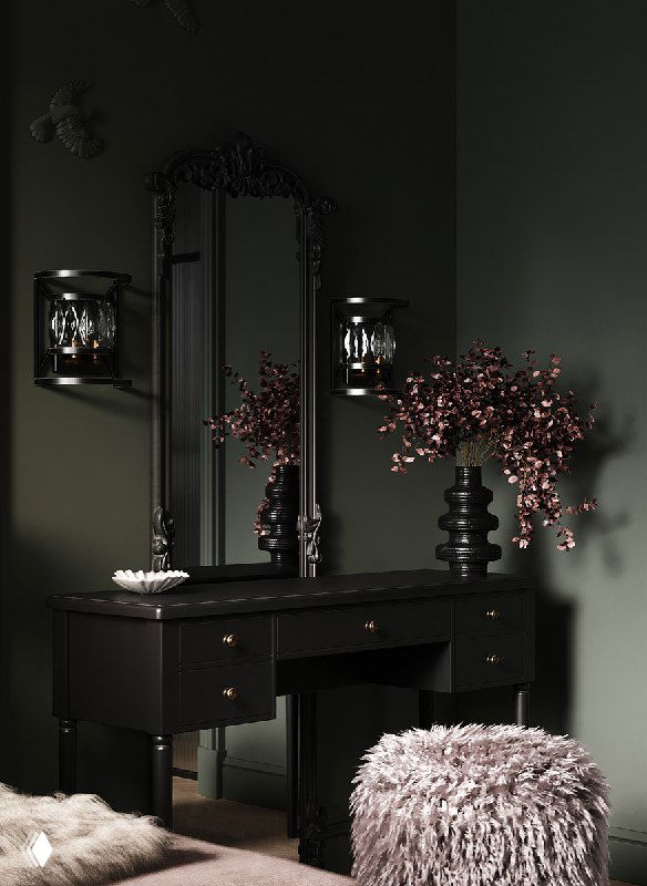Буарный столик в тёмно‑зелёной комнате: чёрный комод с ящиками, большое резное зеркало, декоративные ветки в вазе и рядом меховой пуф.