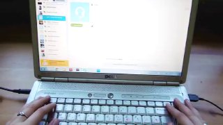 Ноутбук с открытым окном Skype на экране и пальцы печатают на клавиатуре; видно интерфейс приложения и рабочую поверхность ноутбука в домашней обстановке.