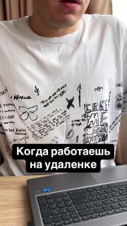 Человек в белой футболке сидит за ноутбуком в домашнем рабочем месте; на изображении видна подпись про работу на удалёнке.