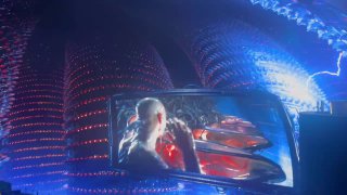 Часть изогнутого экрана с крупным планом сценки из фильма и переливающимися цветными элементами иммерсивной проекции над зрителем.