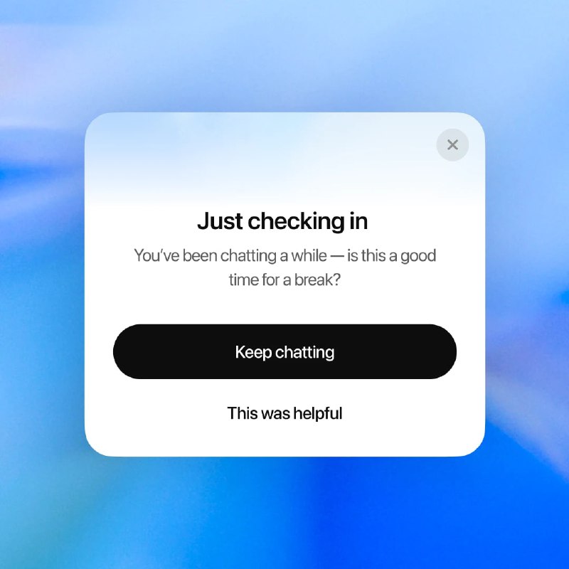 Плашка-напоминание ChatGPT на размытом синем фоне: белая карточка с текстом «Just checking in», кнопками и предложением сделать перерыв