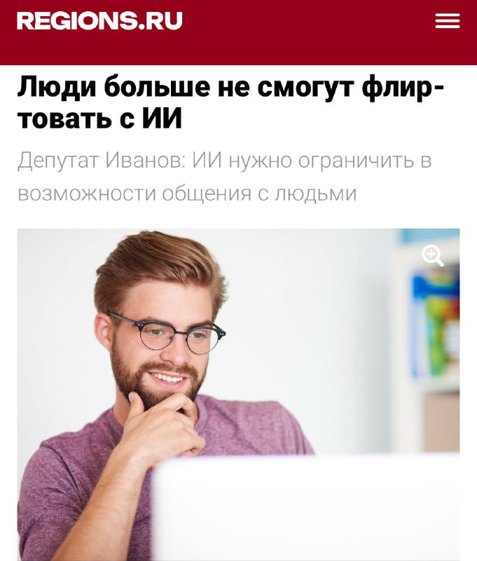 Мужчина в очках улыбается за ноутбуком на фоне веб‑страницы; изображение к новости о предложении запрета флирта с ИИ.