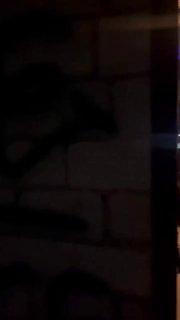Тёмное вертикальное фото внутренней стены или интерьера клуба с плиткой и неясным граффити/тенью, слабое освещение, атмосферный кадр.