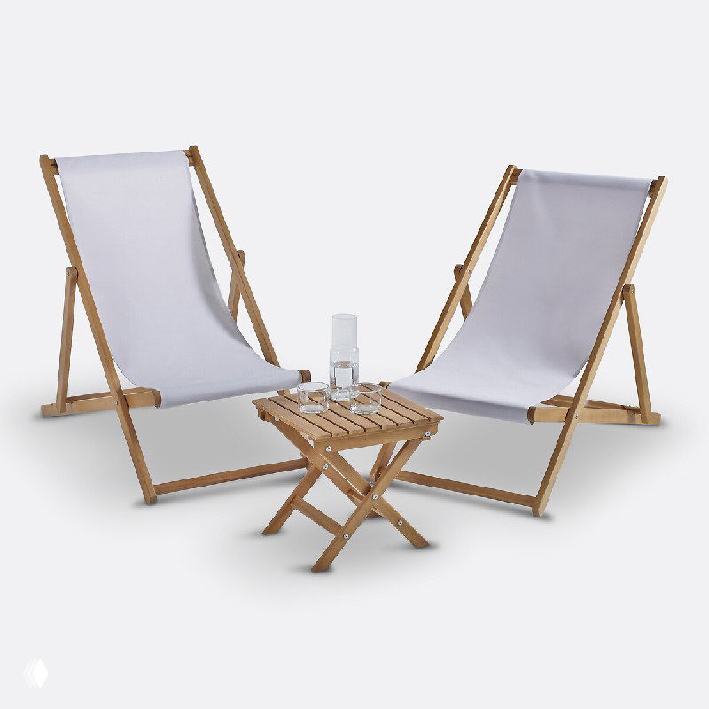 Комплект из двух деревянных шезлонгов с белой тканевой обивкой и складного столика, фотосъемка на нейтральном фоне, идея для зоны отдыха в саду или на балконе.