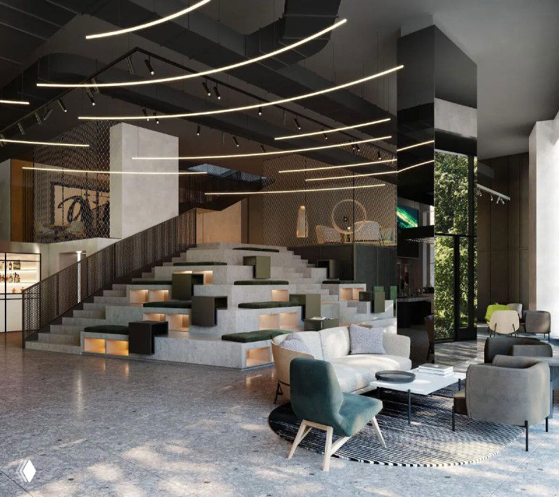Интерьер лобби отеля SIRO: современная лаунж‑зона с многоуровневой посадкой, мягкими креслами и декоративным освещением в светлых тонах.