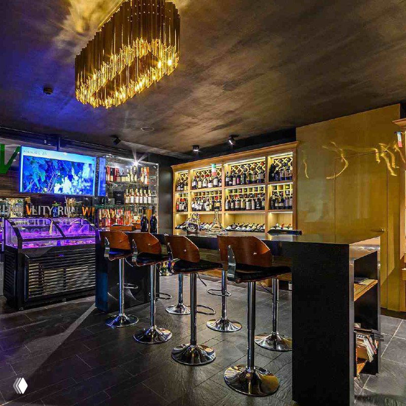 Интерьер винного бутика и бара Wine Store при First & Only: стойка, стеллажи с бутылками и приглушённое тёплое освещение для комфортных дегустаций.
