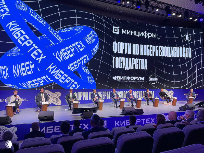 Панельная сессия форума Кибертех: сцена и большой экран с надписью «Форум по кибербезопасности государства», выступающие на сцене и аудитория в зале.