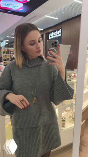 Фотография модели в зеркале в магазине Rosone, на ней надето колье и кольцо из коллекции Storia Moderna di Venezia — пример носки комплекта в торговом пространстве.