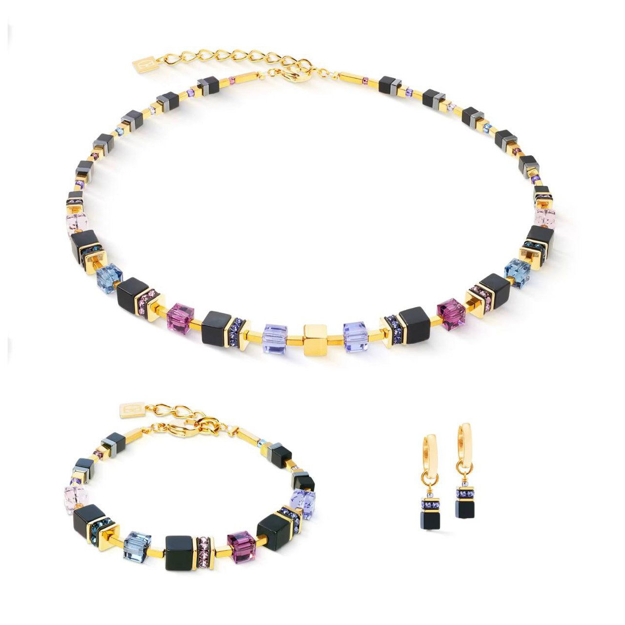 Комплект Coeur de Lion: колье, браслет и серьги с разноцветными кубическими кристаллами и золотистыми элементами на белом фоне для каталога Rosone.
