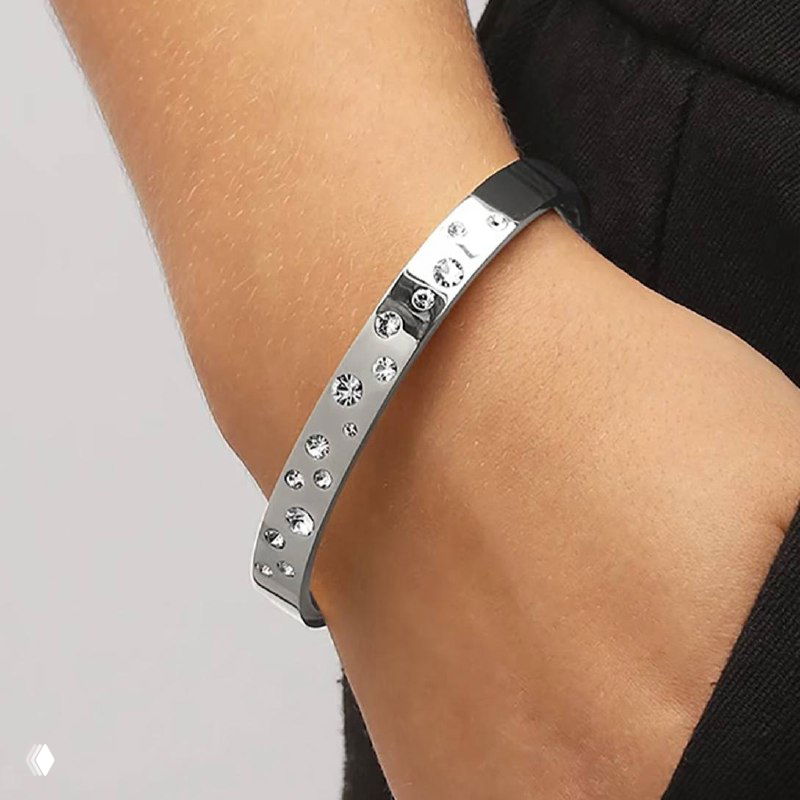 Серебристый бэнгл с рядом блестящих кристаллов на запястье, жесткий браслет Dyrberg Kern в стильной металлической отделке для эффектного акцента.