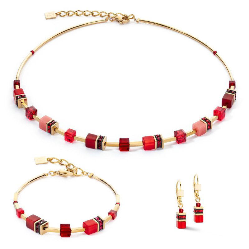 Красный комплект Coeur de Lion: колье, браслет и серьги в ярких насыщенных красных оттенках с золотистыми вставками на белом фоне.