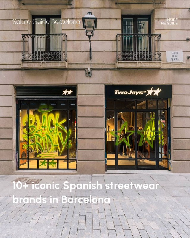 Barcelona shopfront with 'TwoJeys' signage and window displays showing neon-yellow graffiti-style artwork against a stone facade.