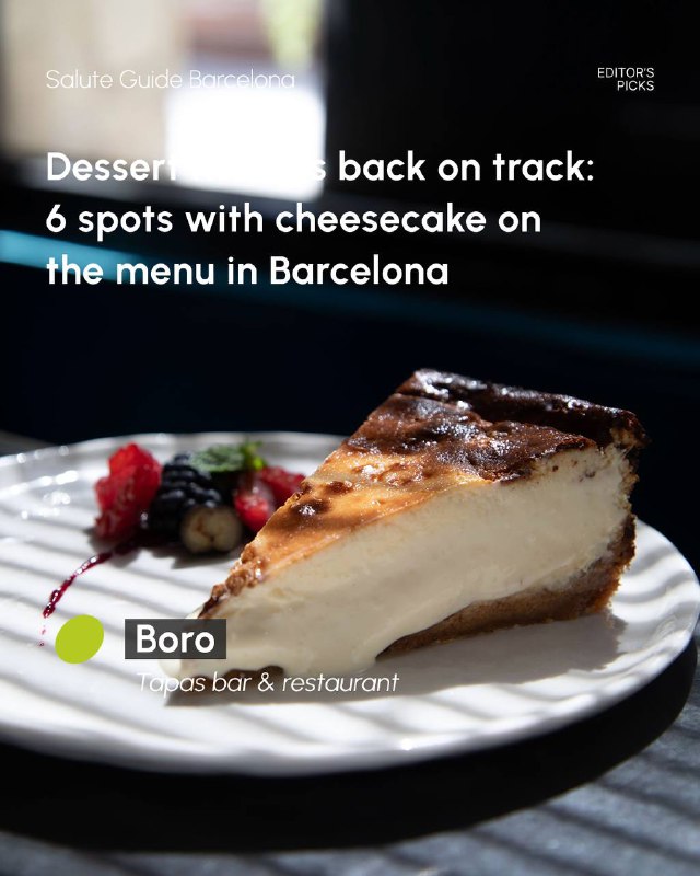 Plate with a slice of cheesecake garnished with berries, shallow focus shows the dessert in a restaurant or bistro environment.