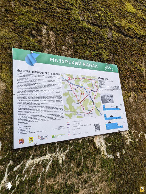 Информационная табличка «Мазурский канал» с картой и исторической справкой, закреплённая на бетонной стене у шлюза №2.